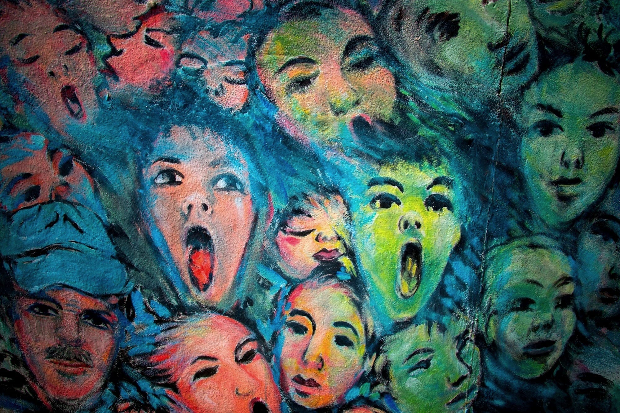 A close-up of a painting of tightly packed human faces