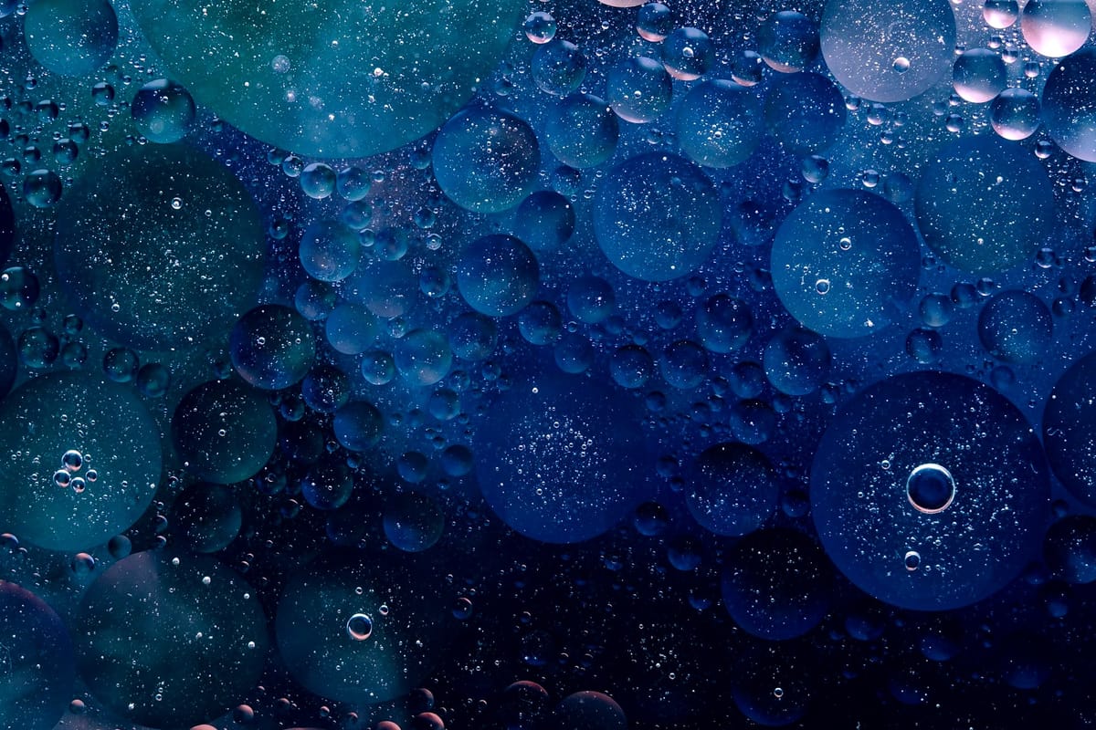 A geometric rendering of large navy blue water bubbles.