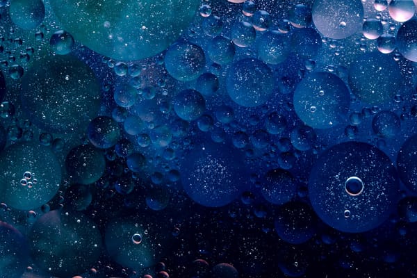 A geometric rendering of large navy blue water bubbles.