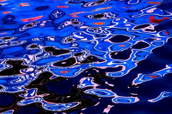 Oil-on-water painting of rippling water.