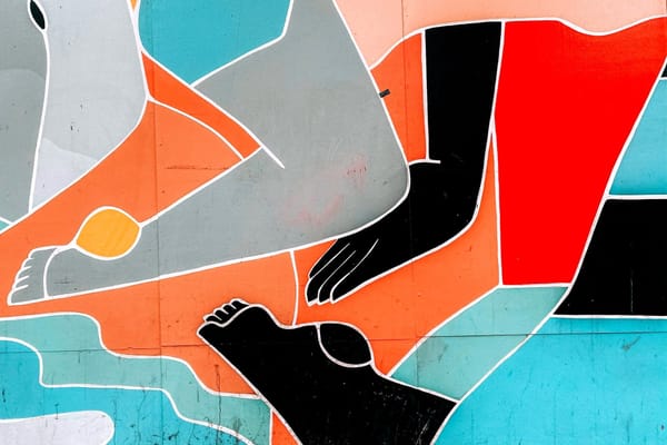 An abstract, modern art piece showing colorful shapes and floating limbs.
